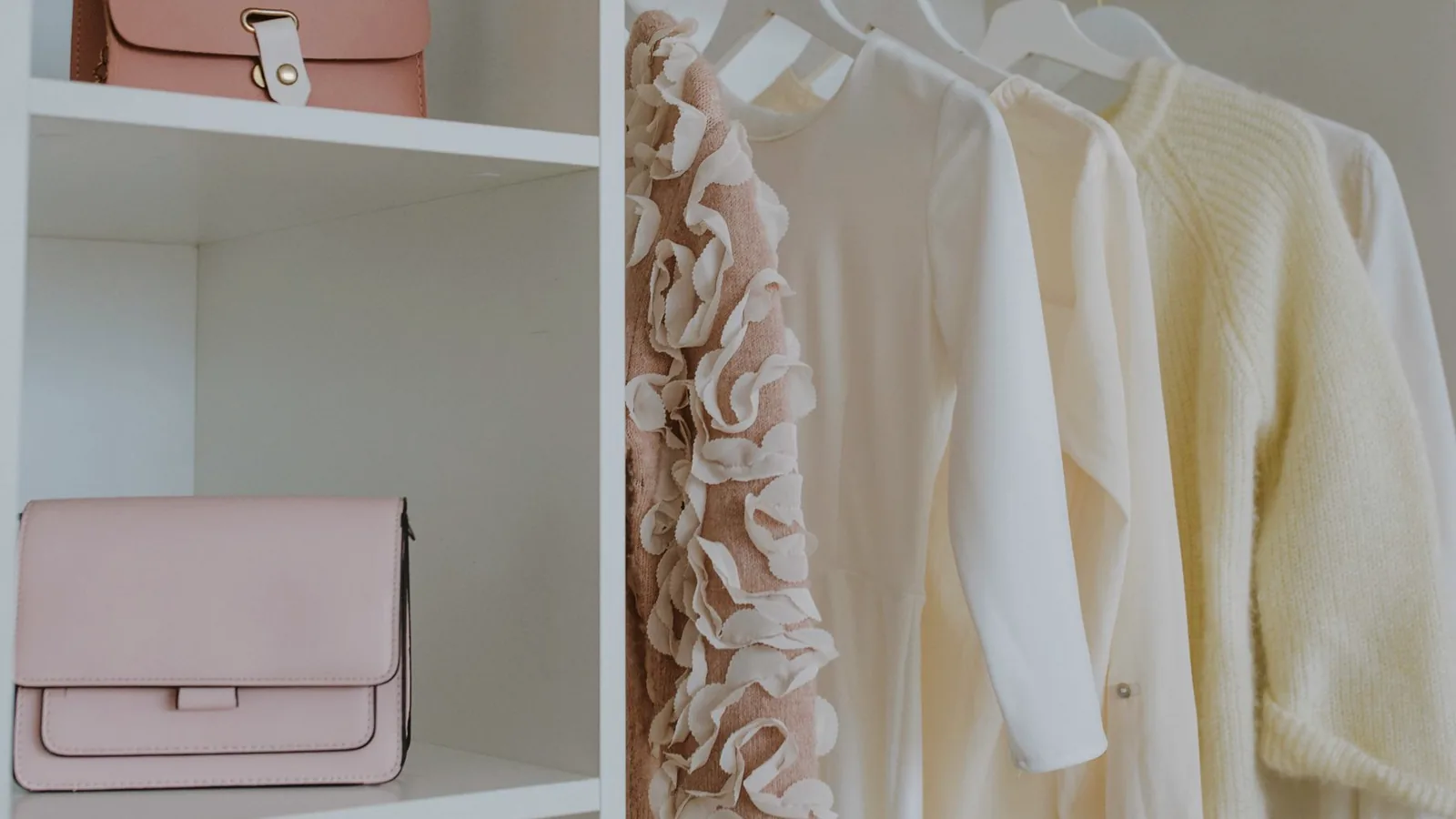 An open wardrobe with clothes hung neatly in order