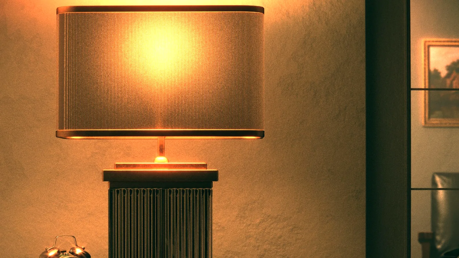 A warm table lamp and a clock glowing on a bedside table at night