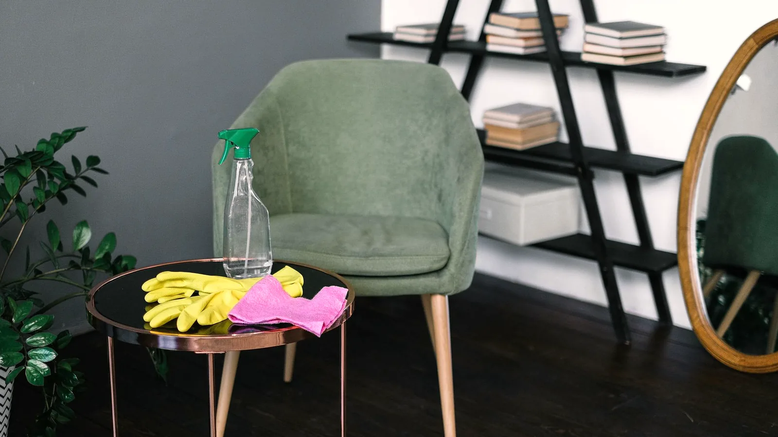 Cleaning supplies laid out on a table in front of an armchair