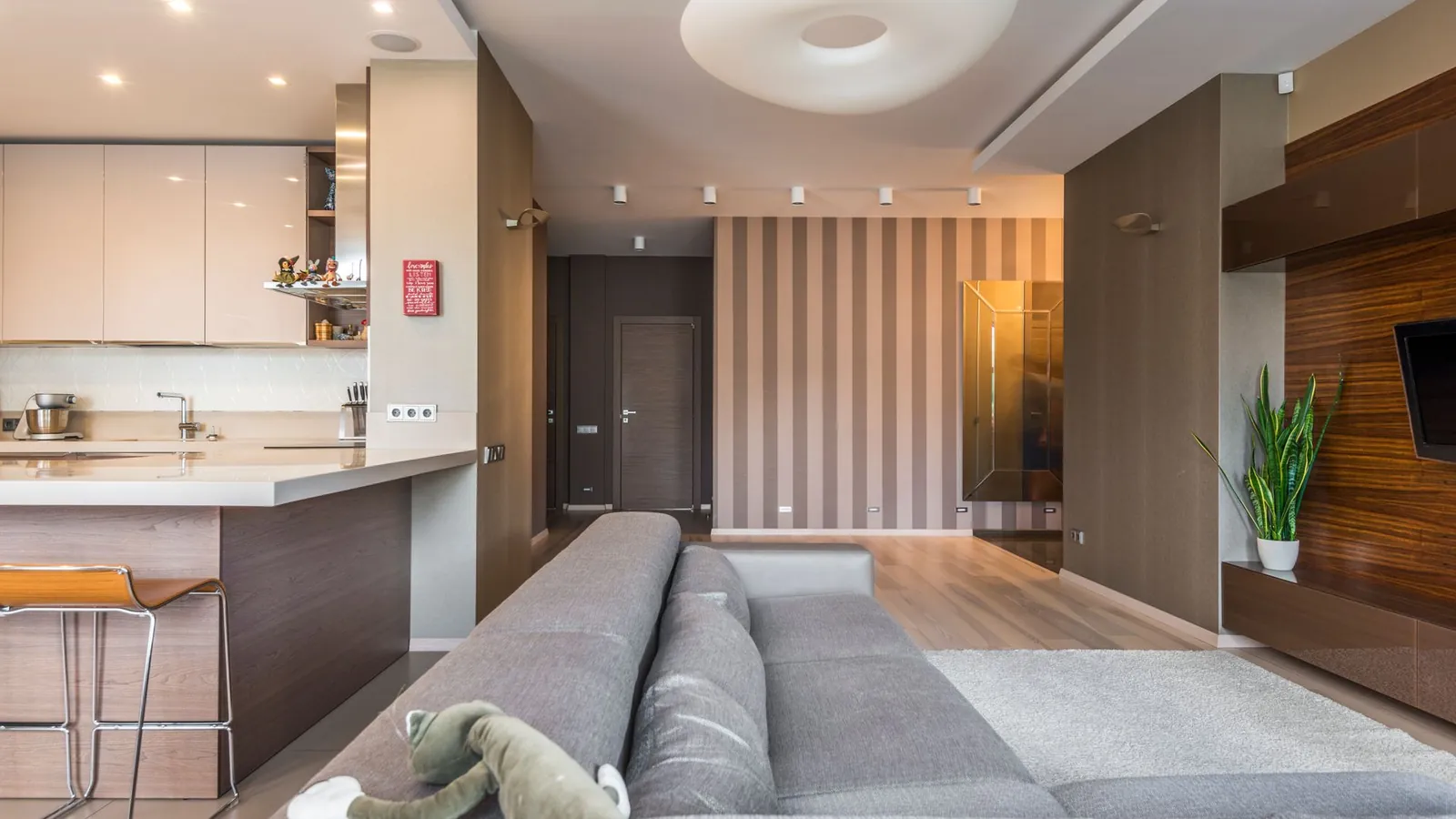 A bright modern living room with an open kitchen in the background