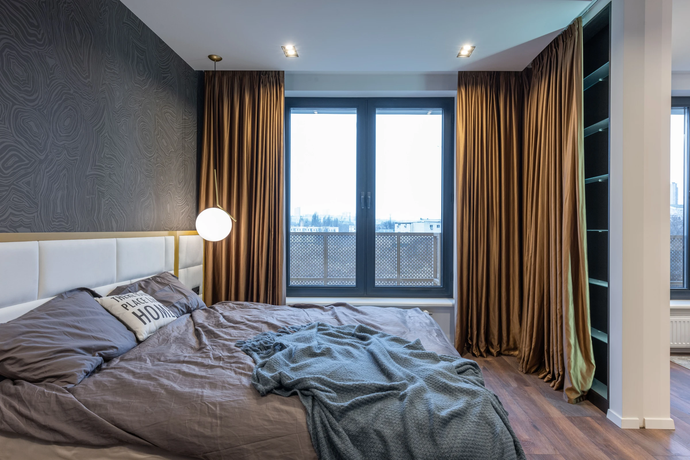 A bedroom with curtains framing the window; window-treatment context.