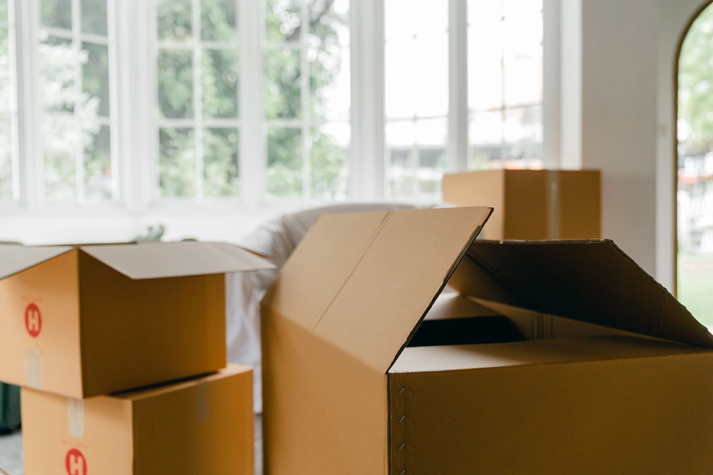 Moving boxes in a room; delivery and purchase-planning context.