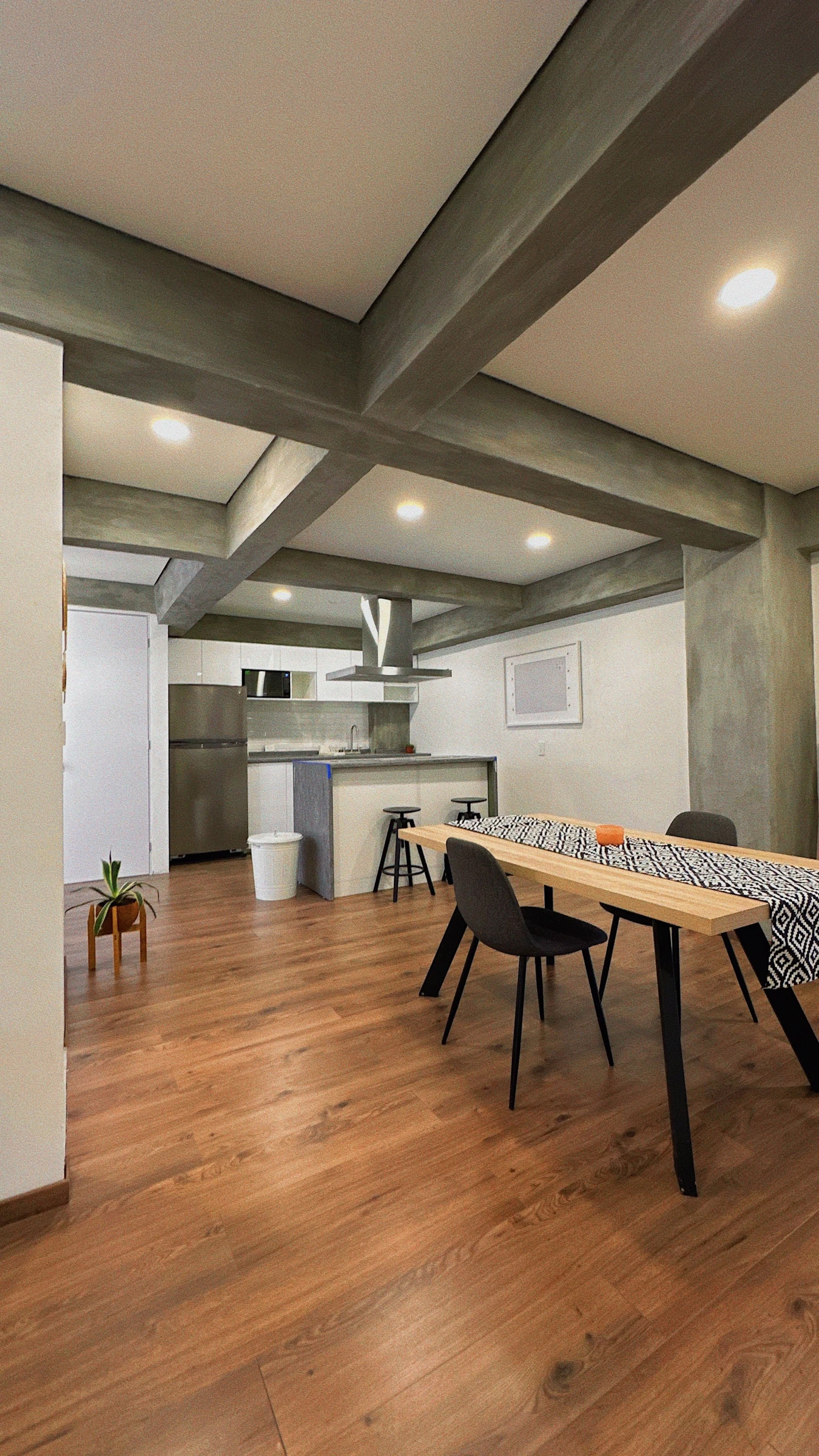 An apartment dining area beside a compact kitchen; room-planning context.