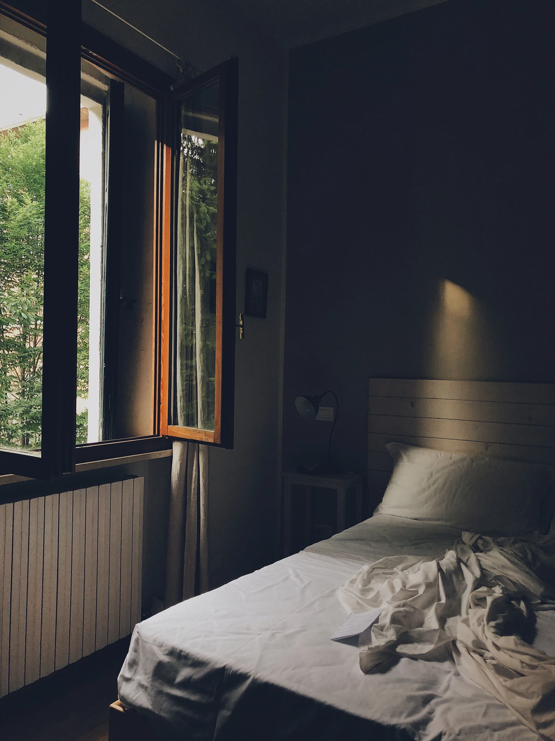 A bedroom beside a window. Bedside-space context, not an IKEA LACK product photo.