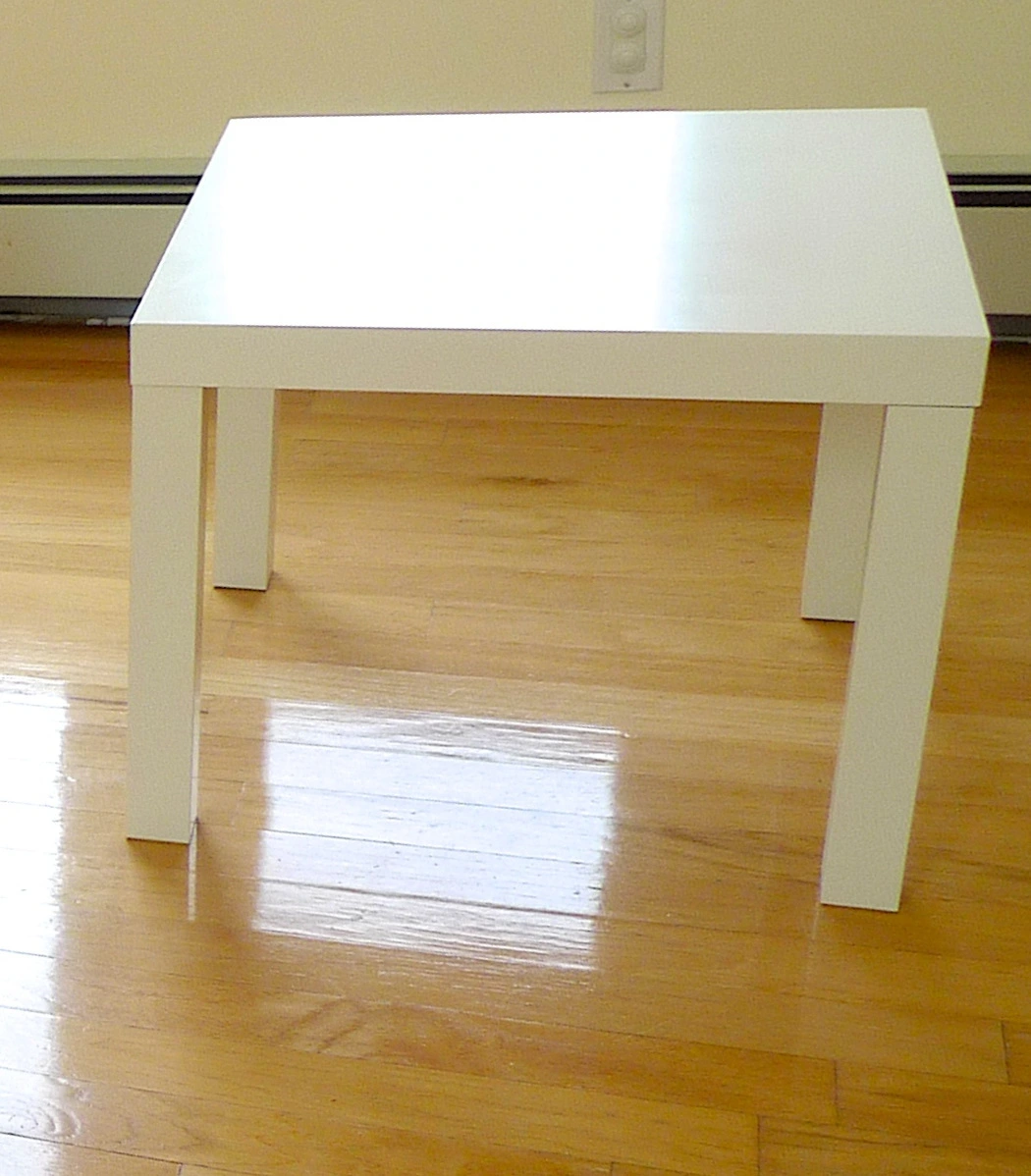 Full white IKEA LACK square side table with all four legs visible