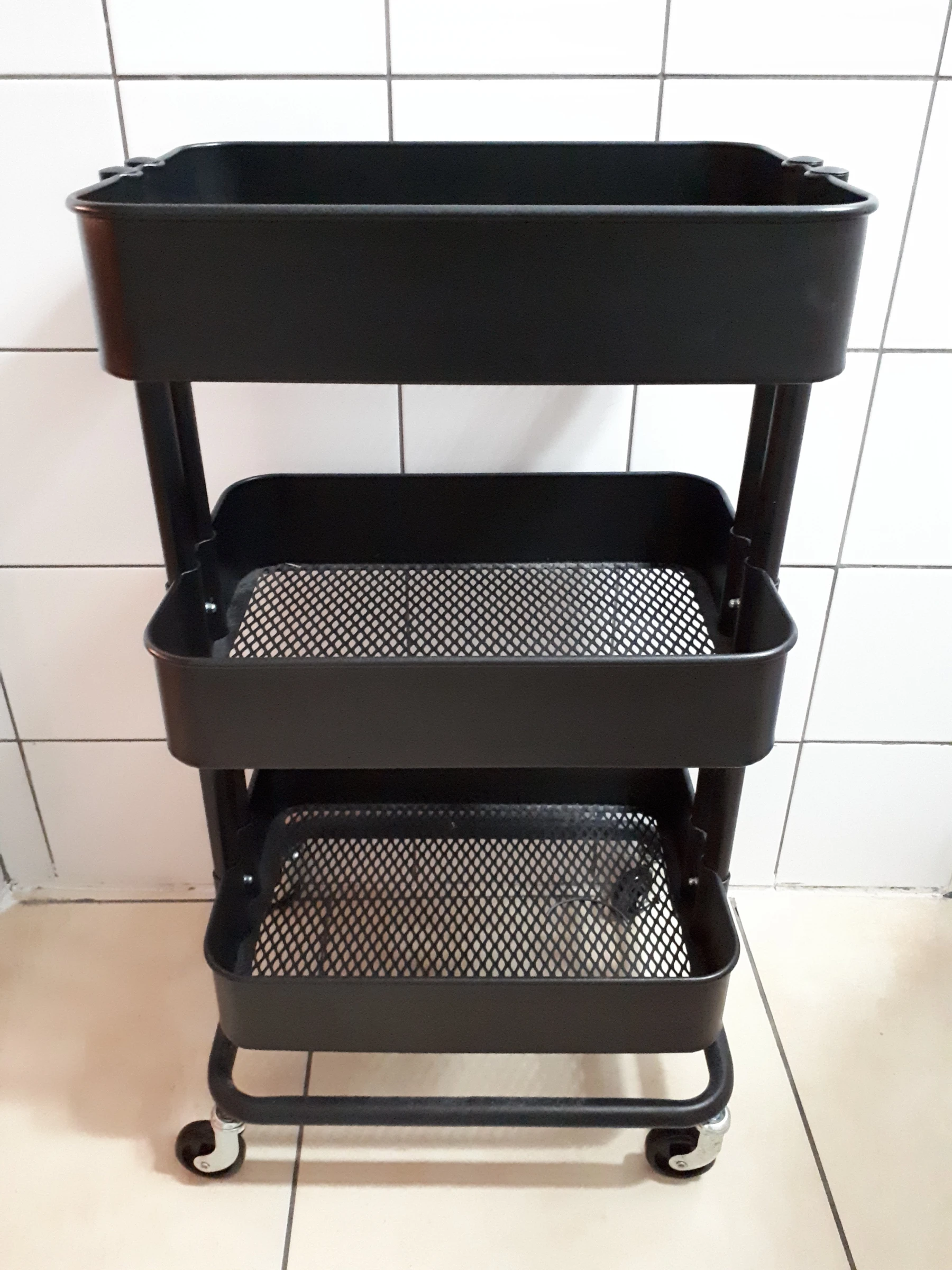 Black IKEA RÅSKOG utility cart photographed in 2017, view 1. Historical product-family photo; not a Nestdusk test unit or confirmation of current specifications.