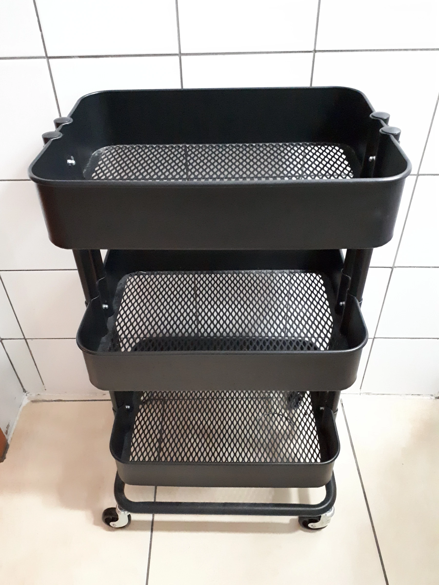 Black IKEA RÅSKOG utility cart photographed in 2017, view 2. Historical product-family photo; not a Nestdusk test unit or confirmation of current specifications.