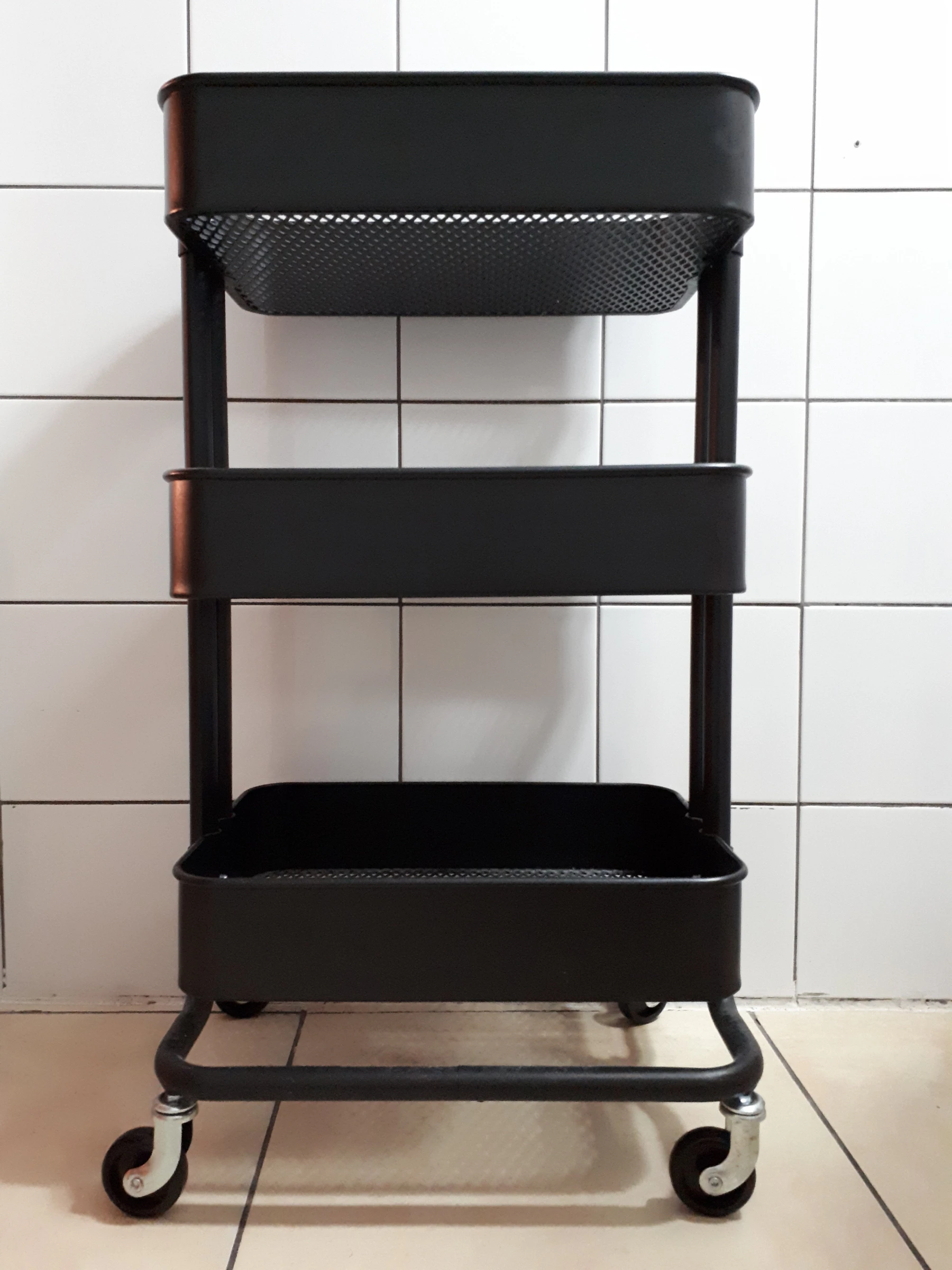 Black IKEA RÅSKOG utility cart photographed in 2017, view 3. Historical product-family photo; not a Nestdusk test unit or confirmation of current specifications.