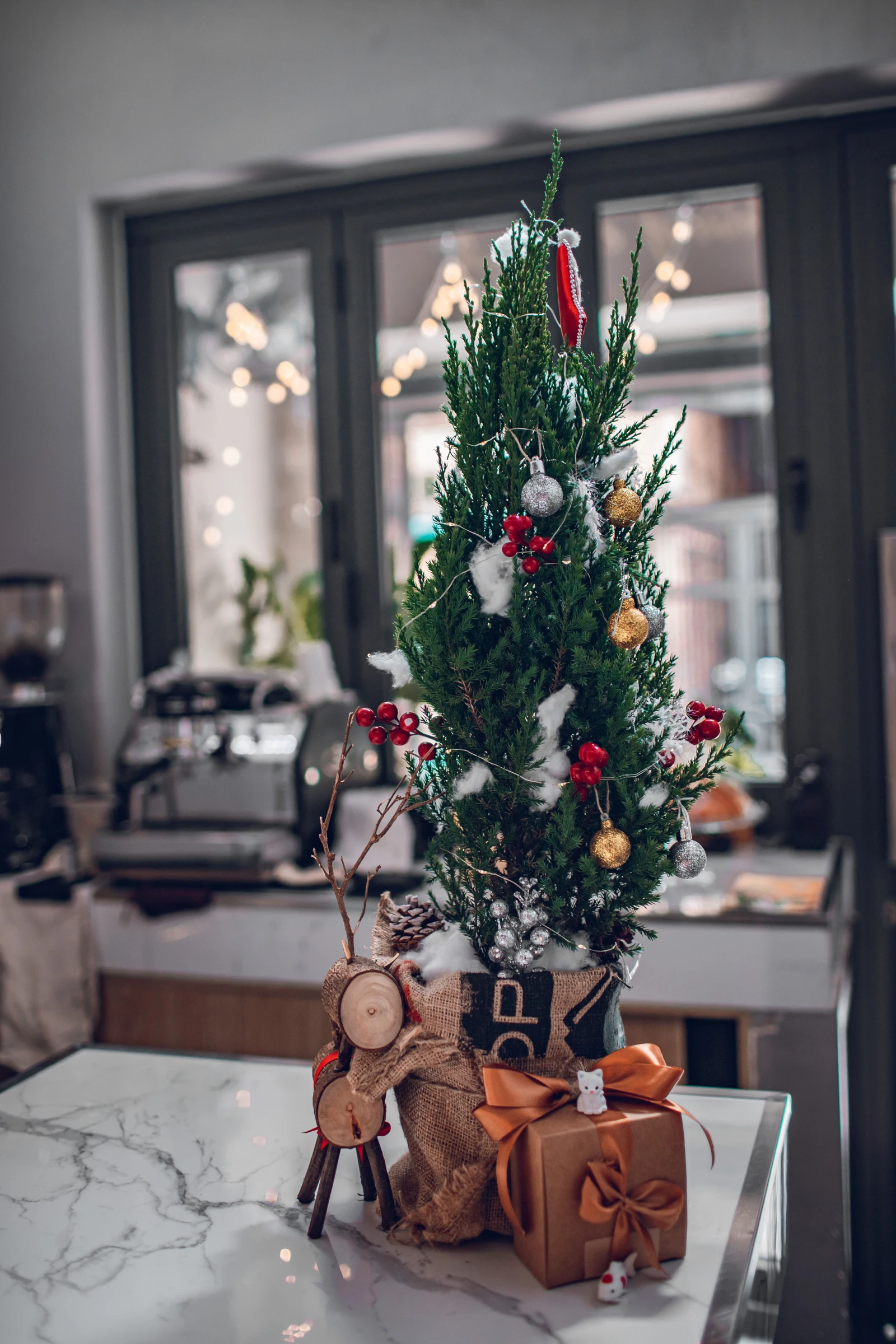 A small decorated tree on a table; seasonal planning context.